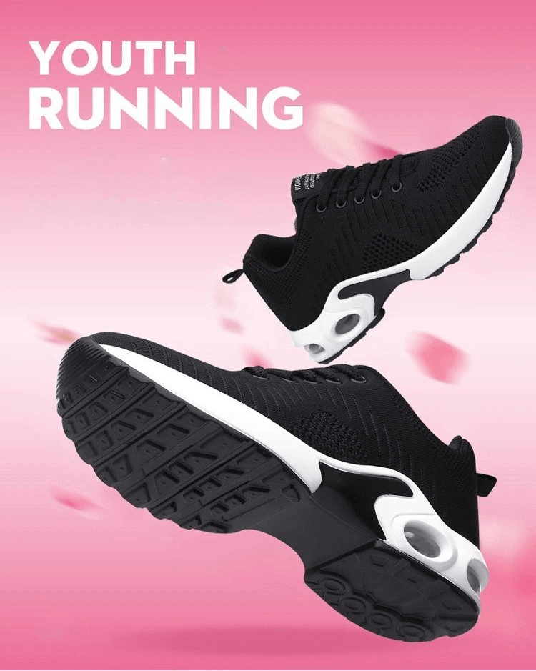 Black breathable women's running shoes with flexible flat soles, designed for youth running, set against a pink background.